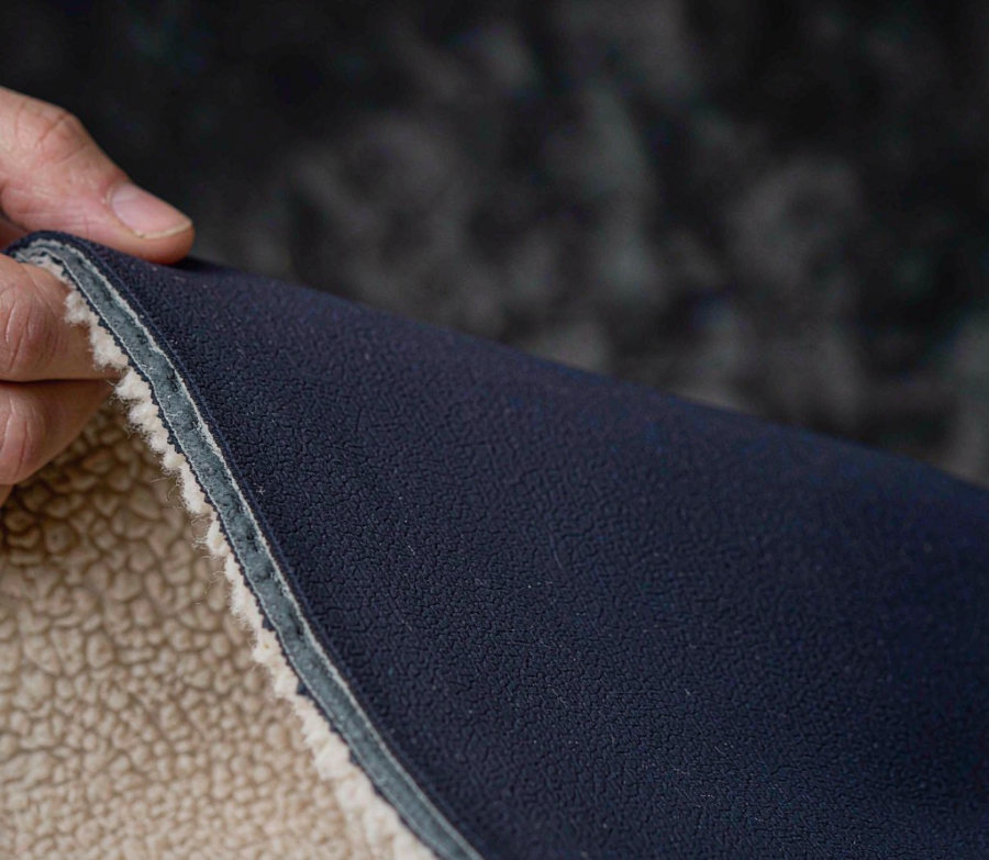 Three-layer bonded softshell fabric cross section in navy