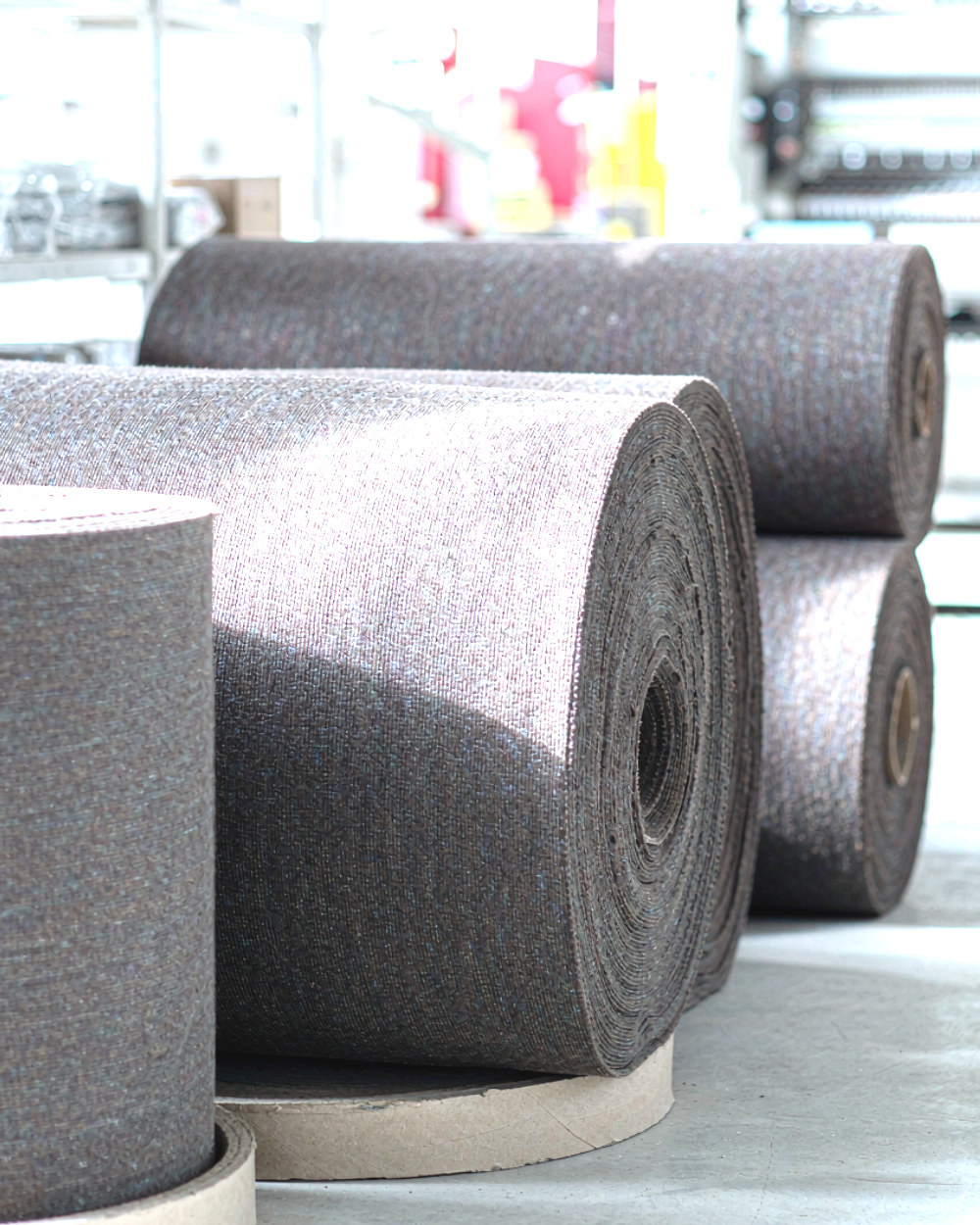 Finished fabric rolls stacked on cores, ready for inspection and packing